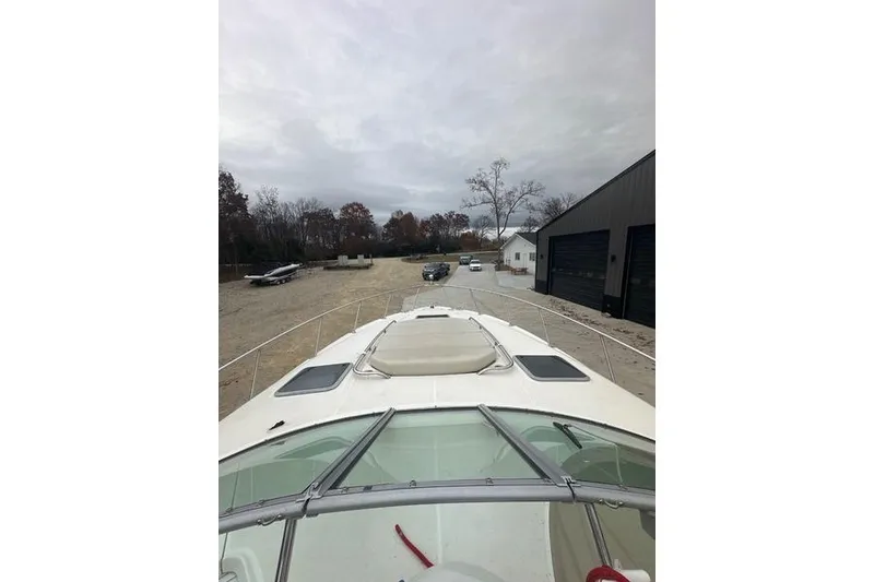 Slide: The Image of 2004 Chaparral Signature 350 boat on land, overcast sky, storage area. - 7