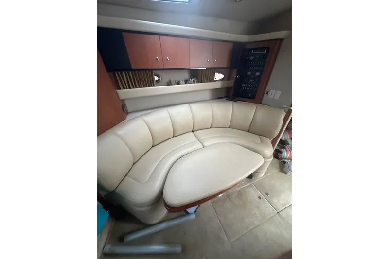 Slide: The Image of Interior of 2004 Chaparral Signature 350 yacht with beige leather seating and wooden cabinets. - 9