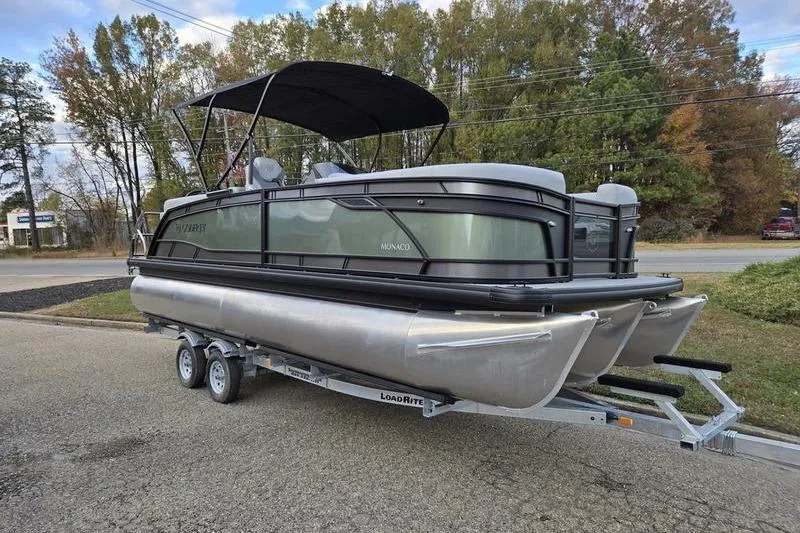 The Image of 2026 Godfrey Monaco 235 SDB pontoon boat on trailer, parked outdoors. - 0