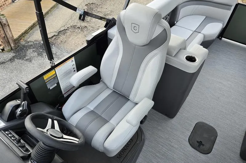Slide: The Image of Captain's seat of 2026 Godfrey Monaco 235 SDB boat, featuring sleek design and modern controls. - 11