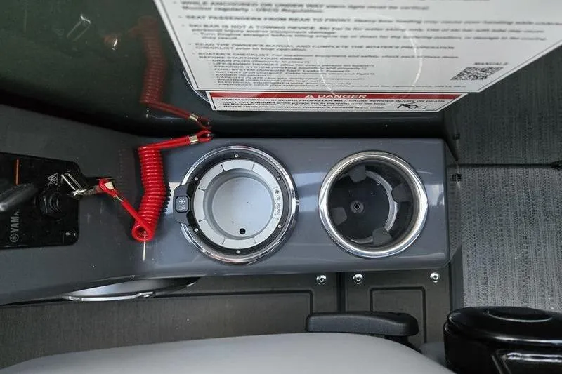 Slide: The Image of Control panel of 2026 Godfrey Monaco 235 SDB with cup holders and safety instructions. - 18