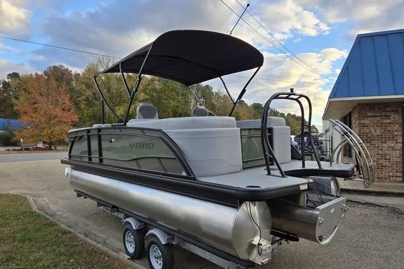 Slide: The Image of 2026 Godfrey Monaco 235 SDB pontoon boat on trailer, parked outdoors. - 2