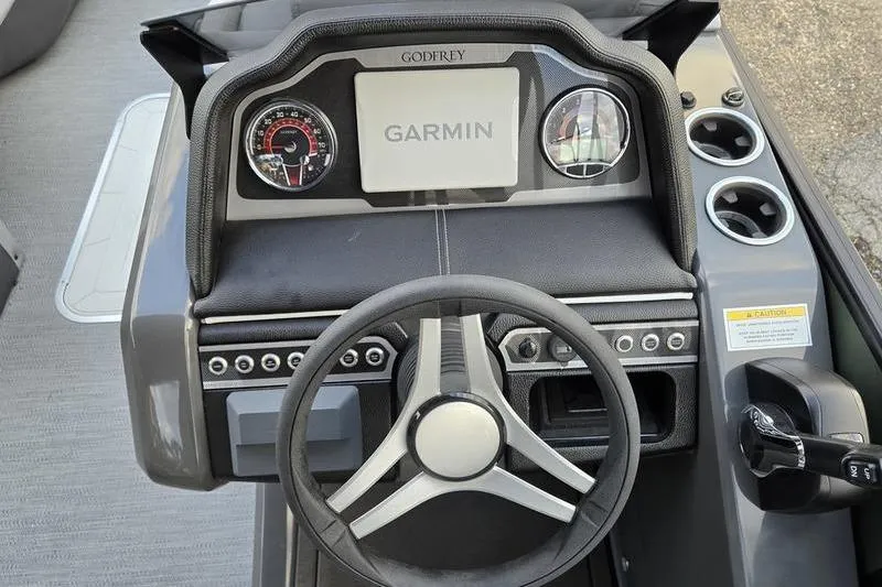 Slide: The Image of 2026 Godfrey Monaco 235 SDB dashboard with Garmin display and steering wheel. - 9