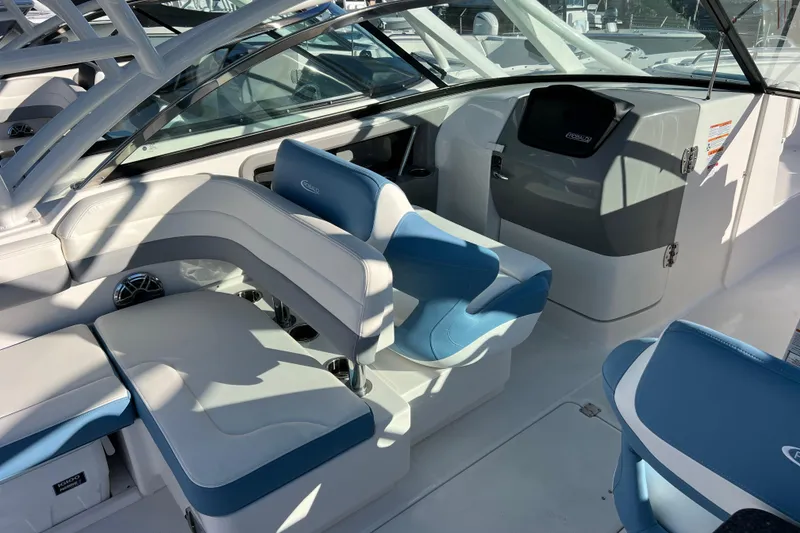 Slide: The Image of 2026 Robalo R317 Dual Console interior with blue and white seating, modern dashboard. - 12