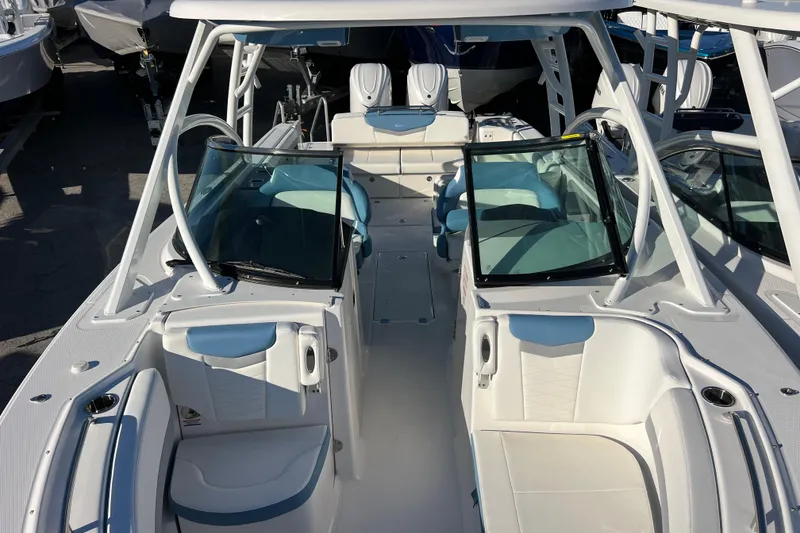 Slide: The Image of 2026 Robalo R317 Dual Console boat interior with white seating and windshield. - 16