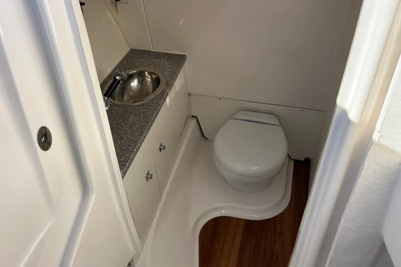 Slide: The Image of 2026 Robalo R317 Dual Console boat bathroom with sink and toilet. - 17