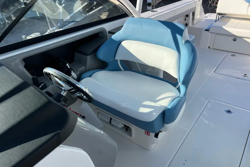 Slide: The Image of 2026 Robalo R317 Dual Console boat interior with blue and white seating. - 18