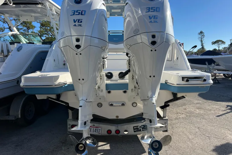 Slide: The Image of 2026 Robalo R317 Dual Console with twin 350 V6 engines, rear view. - 4