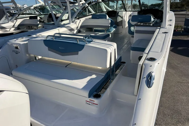 Slide: The Image of 2026 Robalo R317 Dual Console boat interior with white and blue seating. - 5