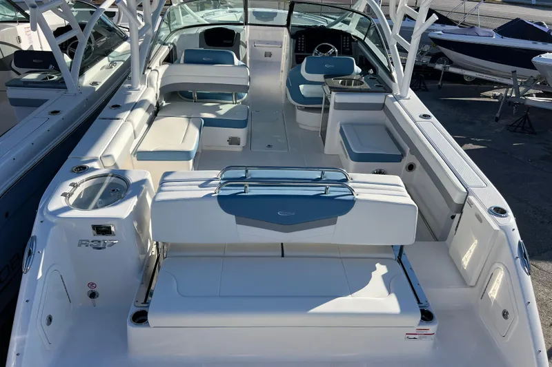 Slide: The Image of 2026 Robalo R317 Dual Console boat interior with seating and helm, docked outdoors. - 7