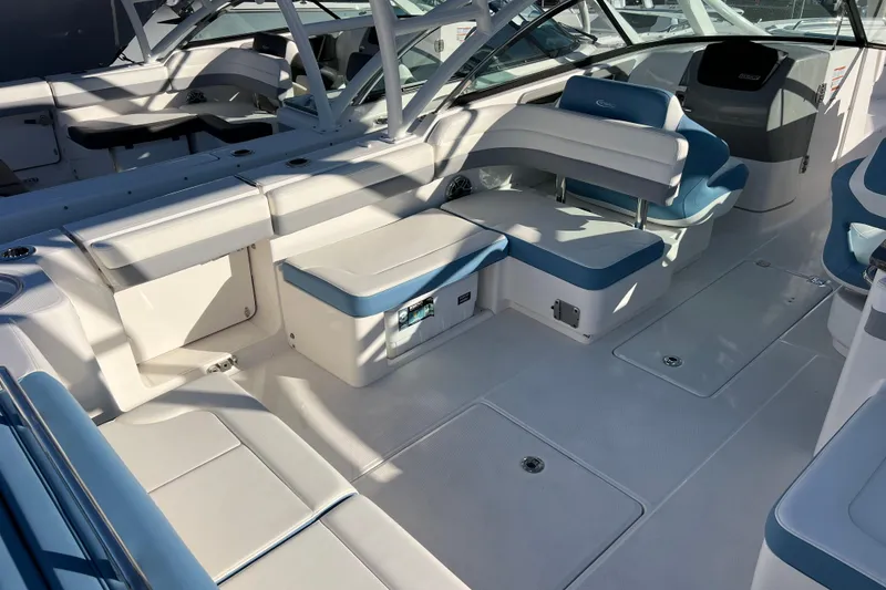 Slide: The Image of 2026 Robalo R317 Dual Console boat interior with white and blue seating. - 8
