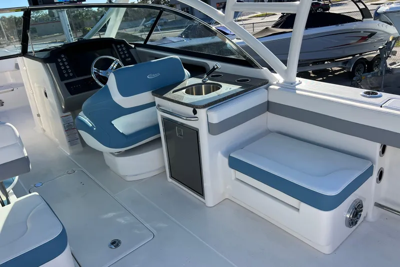 Slide: The Image of 2026 Robalo R317 Dual Console interior with helm, seating, and sink. - 9