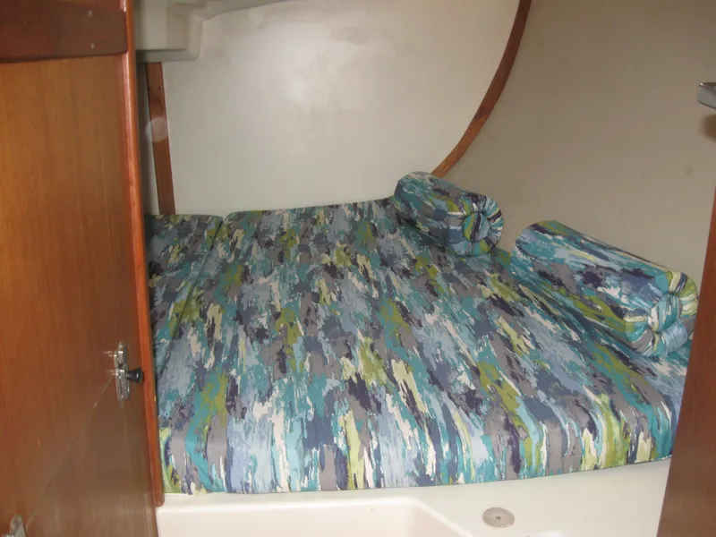 Slide: The Image of Interior of a 1995 Hunter 35.5 yacht with patterned bedding. - 39