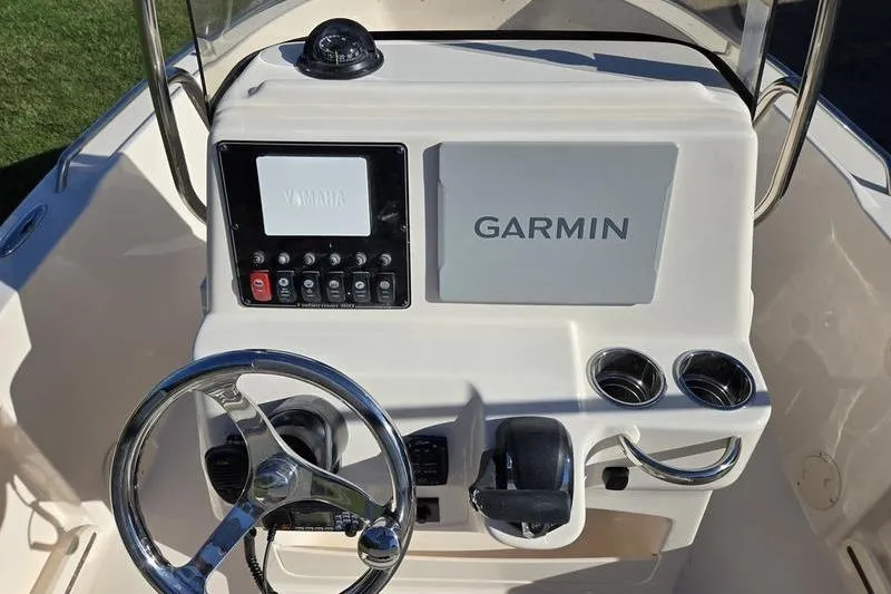 Slide: The Image of 2026 Grady-White Fisherman 180 boat console with Garmin navigation system and steering wheel. - 3