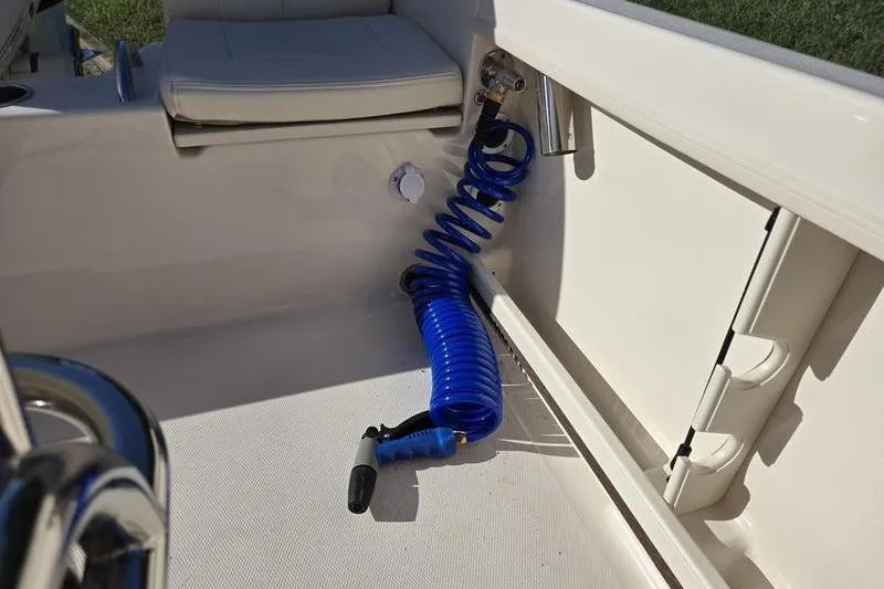 Slide: The Image of 2026 Grady-White Fisherman 180 boat interior with blue coiled hose and seating. - 6