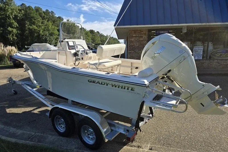 Slide: The Image of 2026 Grady-White Fisherman 180 boat on trailer, parked outside a building. - 9