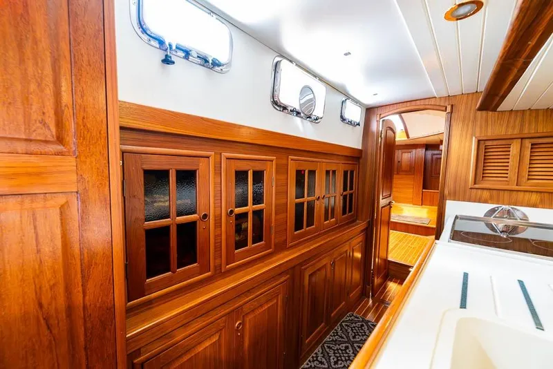 Slide: The Image of Interior of 1974 C&C 61 Ocean Racer/Cruiser with elegant wooden cabinetry and porthole windows. - 32