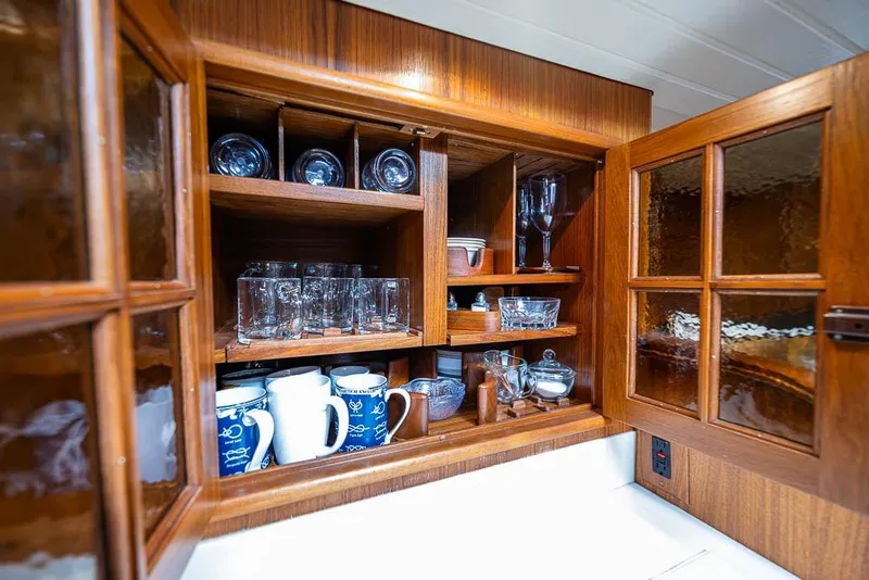 Slide: The Image of Wooden cabinet with glassware and mugs inside a 1974 C&C 61 Ocean Racer/Cruiser. - 35