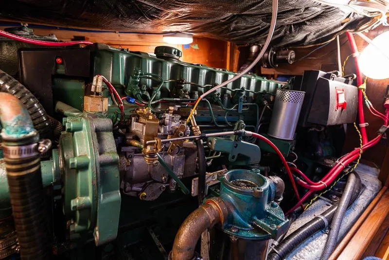 Slide: The Image of Engine room of a 1974 C&C 61 Ocean Racer/Cruiser with visible mechanical components. - 37