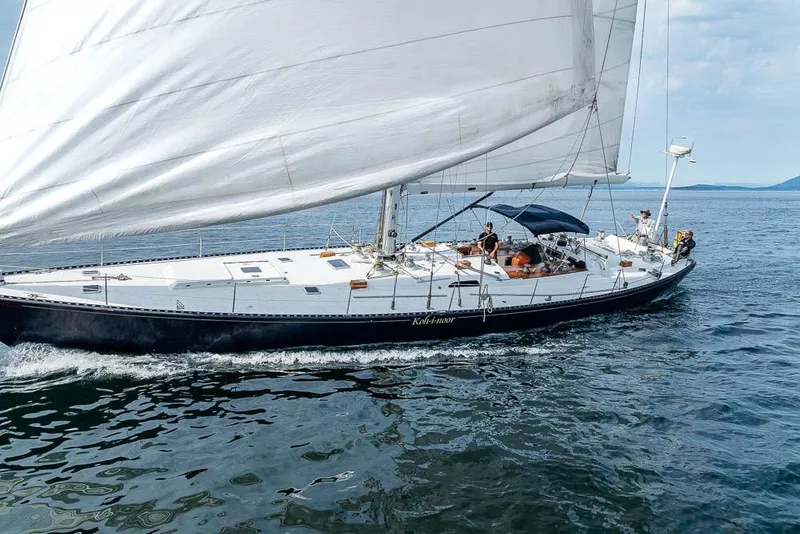 Slide: The Image of 1974 C&C 61 Ocean Racer/Cruiser sailing on open water with full sails. - 4