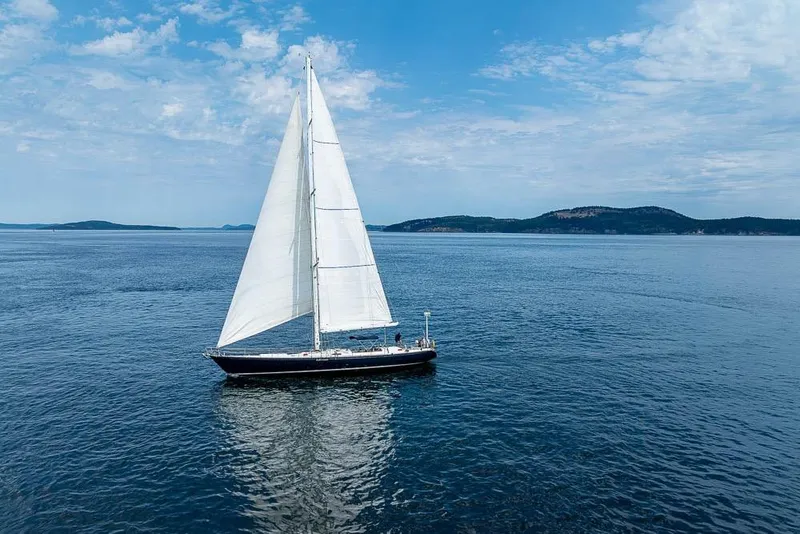Slide: The Image of 1974 C&C 61 Ocean Racer/Cruiser sailing on calm blue waters under a clear sky. - 5