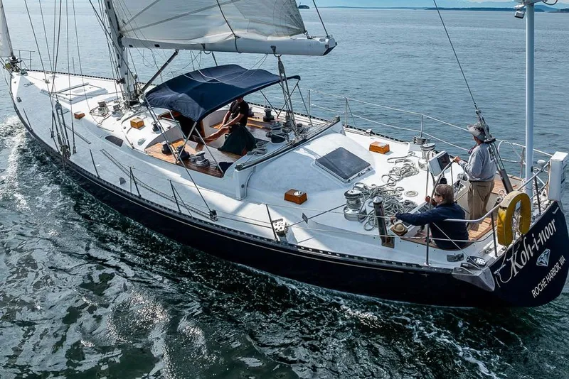 Slide: The Image of 1974 C&C 61 Ocean Racer/Cruiser sailing on open water, featuring sleek design and spacious deck. - 6