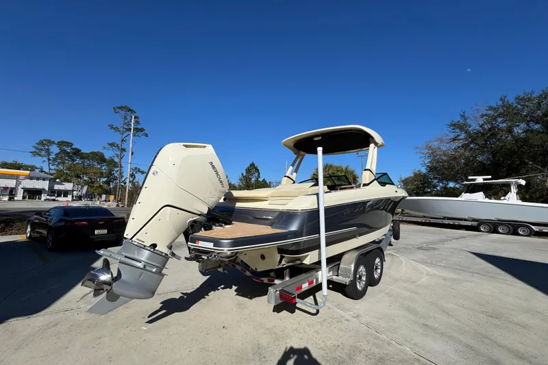 Slide: The Image of 2026 Chris-Craft Sportster 28 boat on trailer, featuring a powerful Mercury outboard motor. - 13