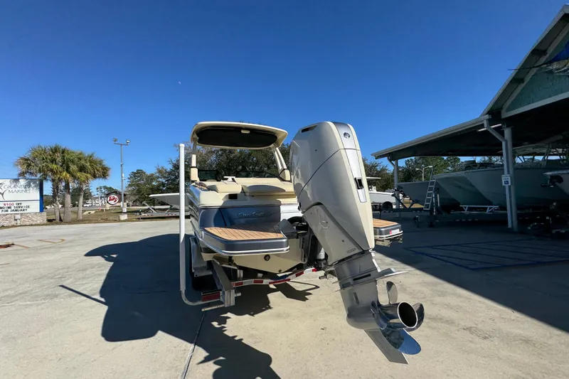 Slide: The Image of 2026 Chris-Craft Sportster 28 boat with powerful outboard motor in a sunny marina. - 16