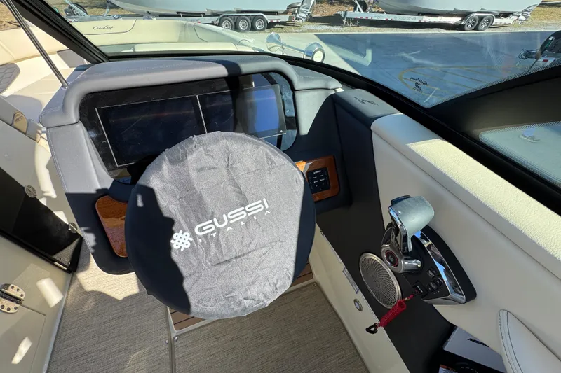 Slide: The Image of 2026 Chris-Craft Sportster 28 dashboard with Gussi Italia steering wheel cover. - 27