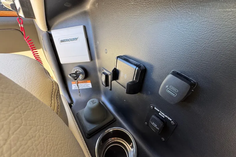 Slide: The Image of 2026 Chris-Craft Sportster 28 dashboard with Mercury controls and switches. - 31