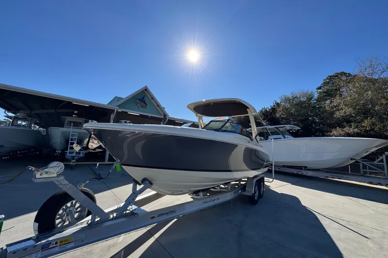 Slide: The Image of 2026 Chris-Craft Sportster 28 boat on trailer under bright sun. - 4