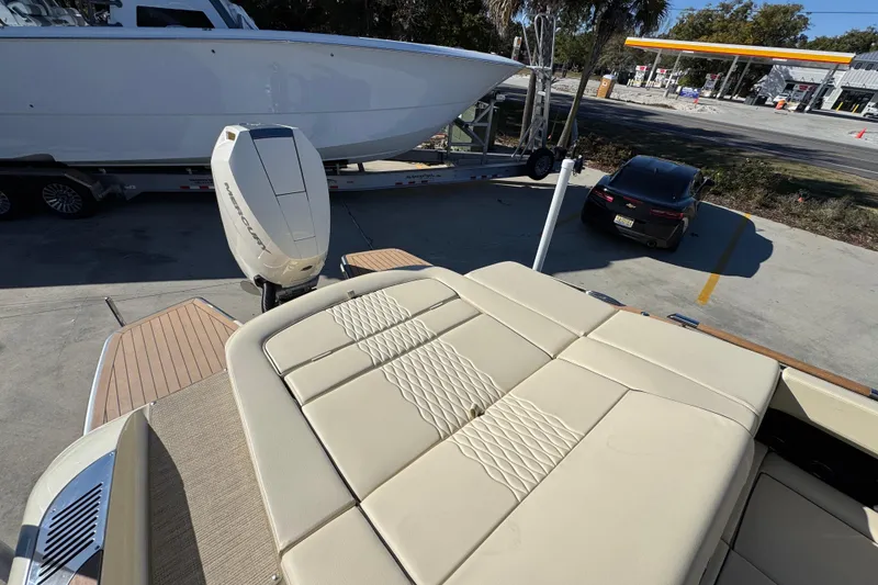 Slide: The Image of 2026 Chris-Craft Sportster 28 boat with luxurious seating and powerful engine, parked near a gas station. - 42