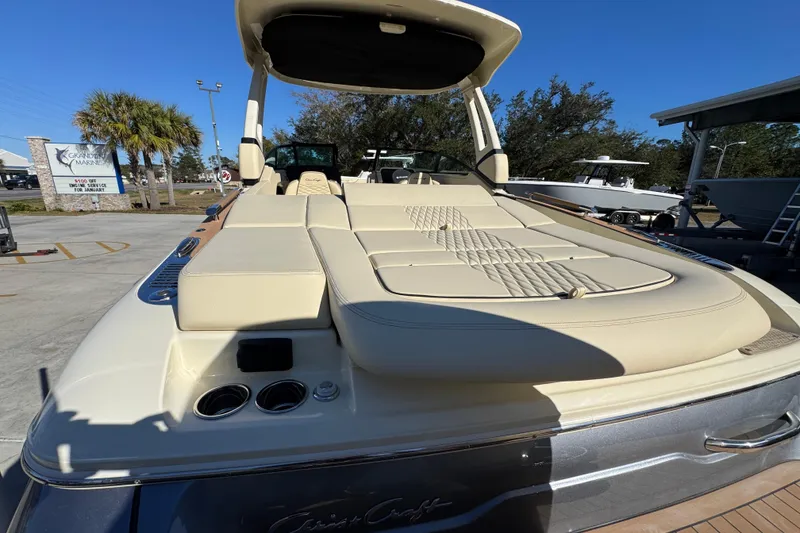 Slide: The Image of 2026 Chris-Craft Sportster 28 boat with luxurious seating, displayed outdoors under clear blue sky. - 43