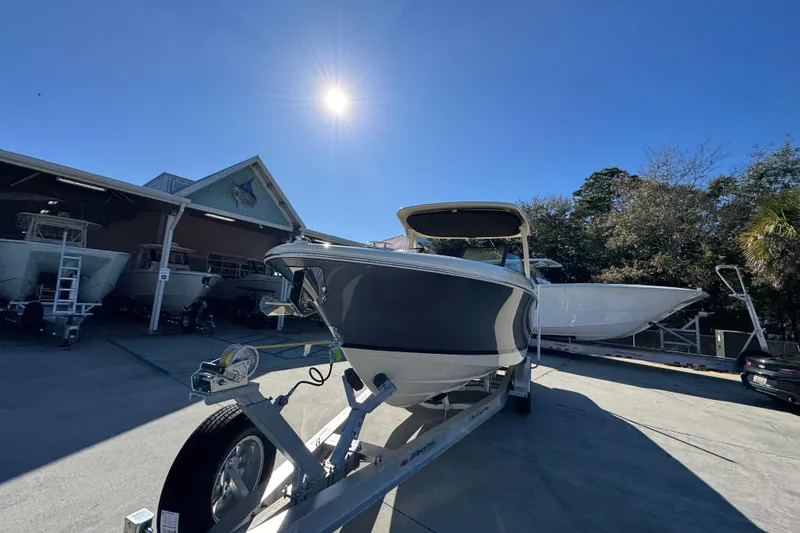 Slide: The Image of 2026 Chris-Craft Sportster 28 boat on trailer under bright sun. - 5