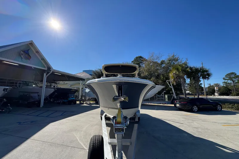 Slide: The Image of 2026 Chris-Craft Sportster 28 boat on trailer under clear blue sky. - 6