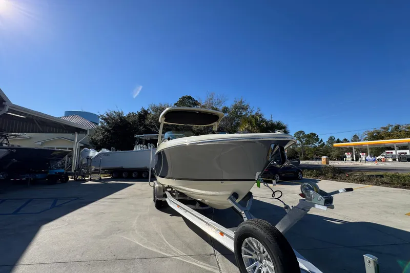 Slide: The Image of 2026 Chris-Craft Sportster 28 boat on trailer under clear blue sky. - 7