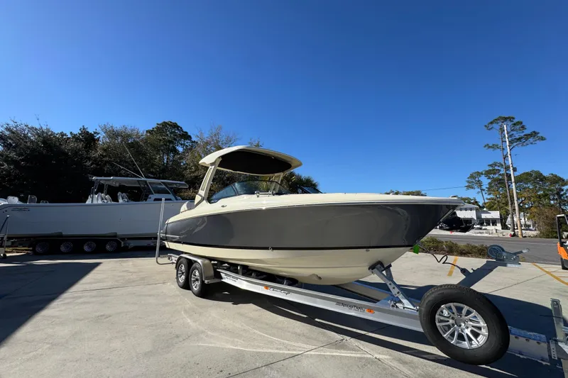 Slide: The Image of 2026 Chris-Craft Sportster 28 boat on trailer under clear blue sky. - 8