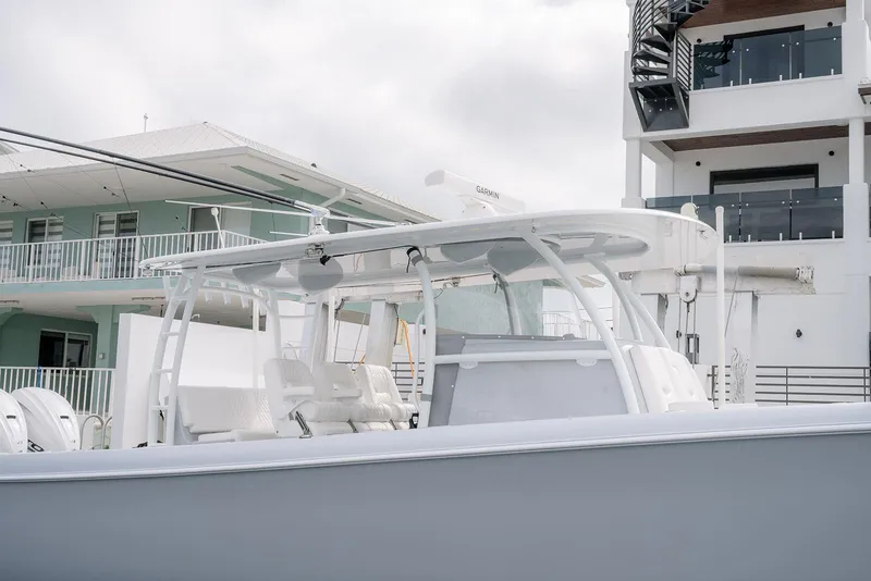 Slide: The Image of 2024 Contender 44 ST boat docked near modern buildings. - 15