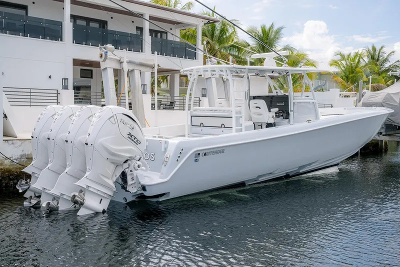 Slide: The Image of 2024 Contender 44 ST boat docked, featuring four powerful outboard engines. - 19