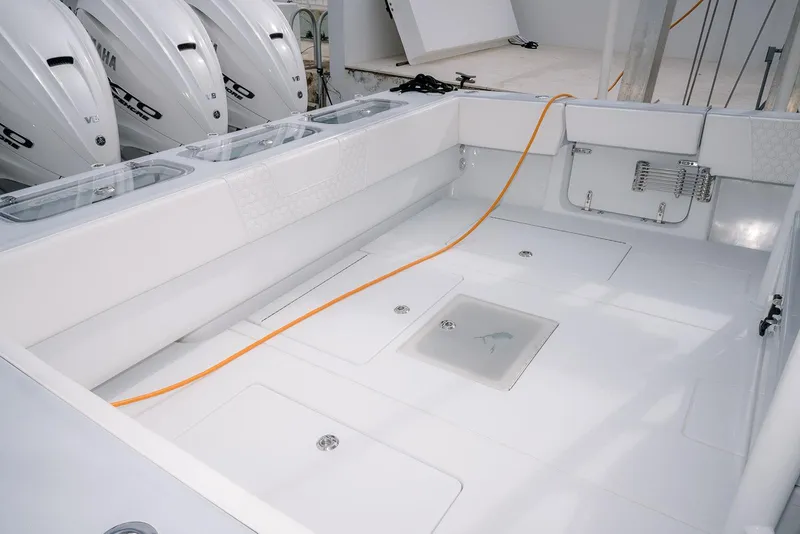 Slide: The Image of 2024 Contender 44 ST boat interior with Yamaha engines, spacious deck, and storage compartments. - 22