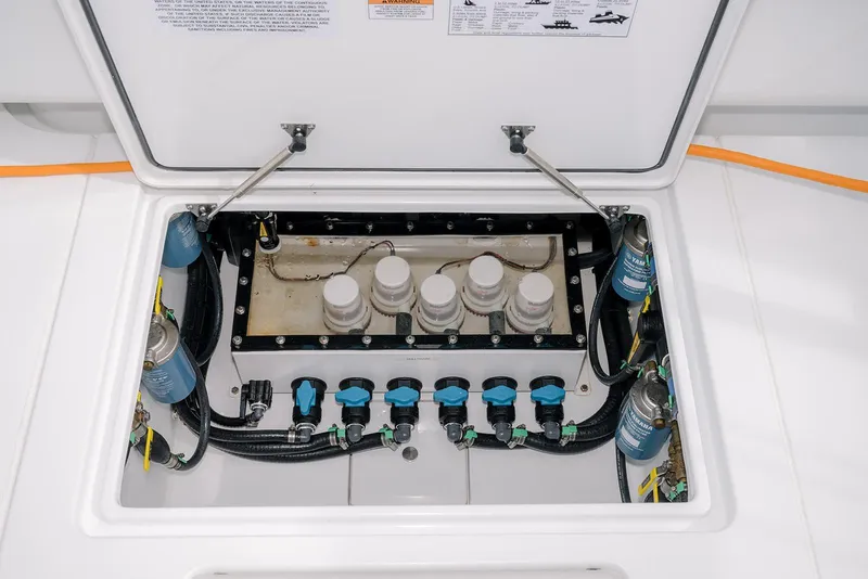 Slide: The Image of 2024 Contender 44 ST boat engine compartment with filters and wiring. - 24