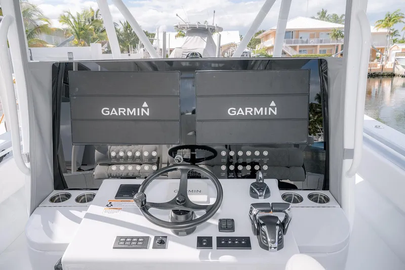 Slide: The Image of 2024 Contender 44 ST boat helm with dual Garmin displays and modern controls. - 31