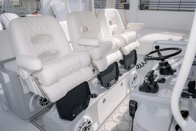Slide: The Image of 2024 Contender 44 ST boat interior with luxurious white seating and modern steering controls. - 33