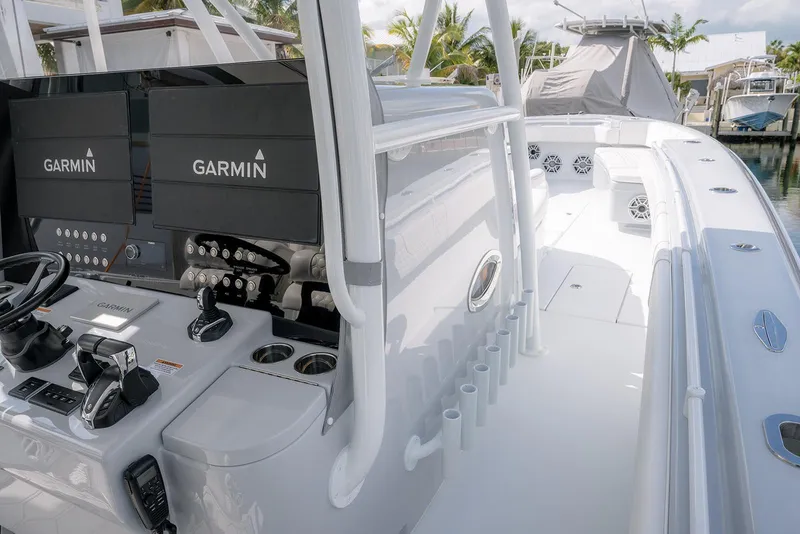 Slide: The Image of 2024 Contender 44 ST boat with Garmin navigation, sleek white interior, and modern controls. - 37