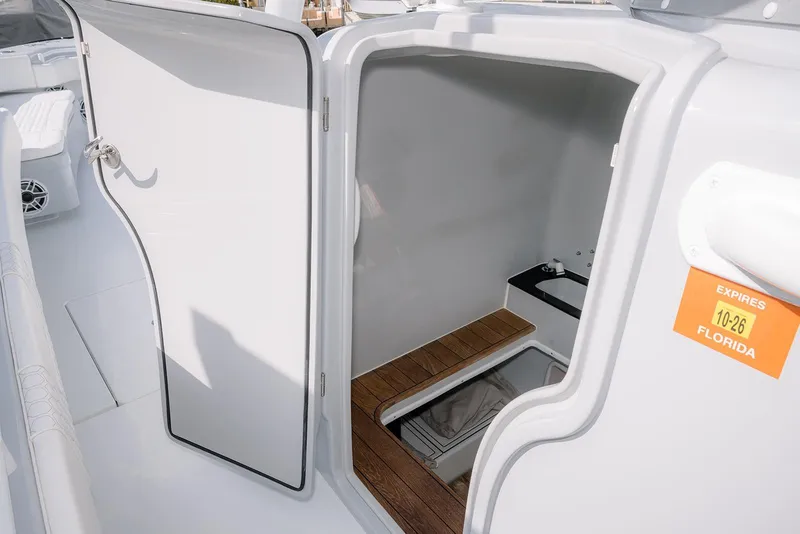 Slide: The Image of 2024 Contender 44 ST boat interior with open cabin door, wooden flooring, and Florida registration sticker. - 39
