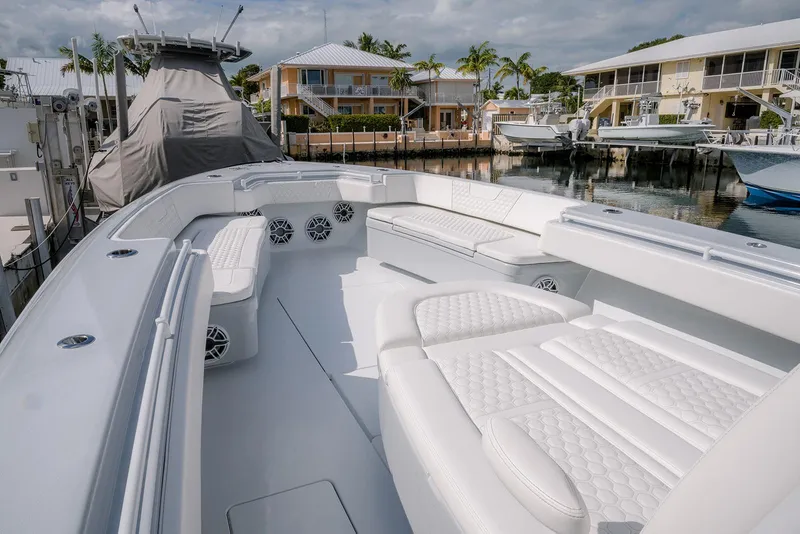 Slide: The Image of 2024 Contender 44 ST boat with luxurious white seating in a marina setting. - 42