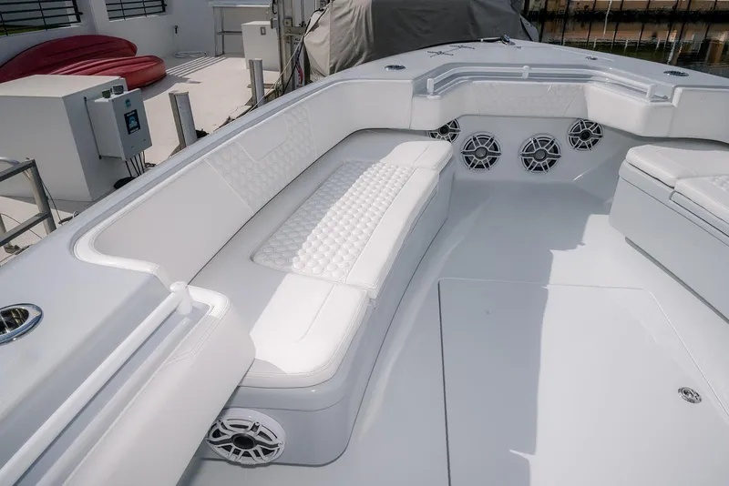 Slide: The Image of Luxurious seating area on 2024 Contender 44 ST boat with white upholstery and speakers. - 44