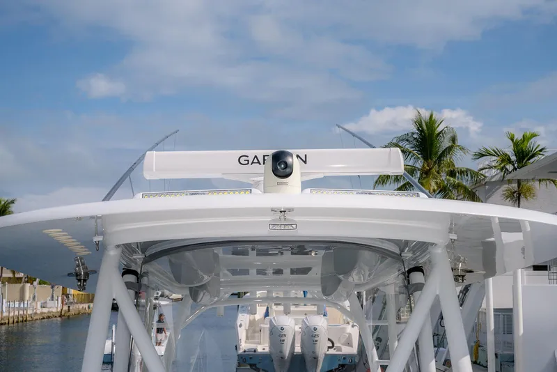 Slide: The Image of 2024 Contender 44 ST boat with Garmin radar, docked near palm trees. - 52