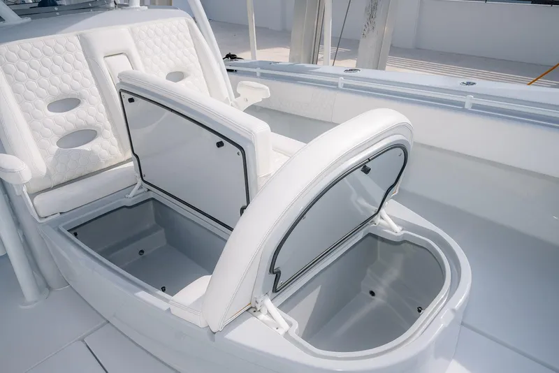 Slide: The Image of 2024 Contender 44 ST boat with open storage compartments and white cushioned seating. - 53