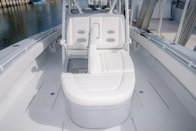 Slide: The Image of 2024 Contender 44 ST boat interior with white cushioned seating and sleek design. - 54